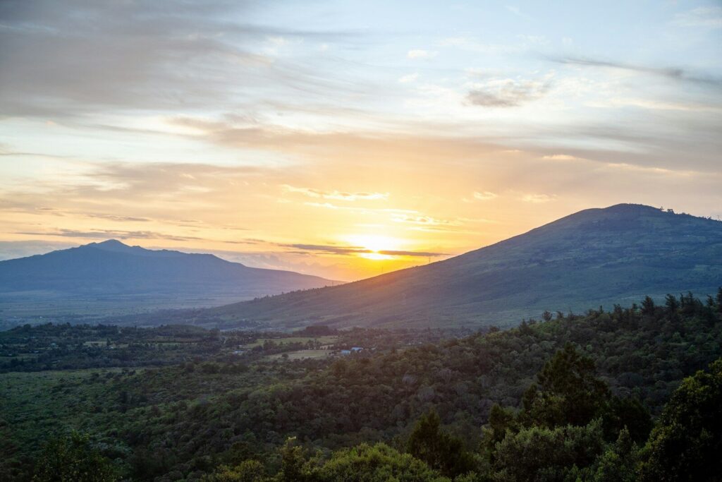 The sun is setting over a mountain range