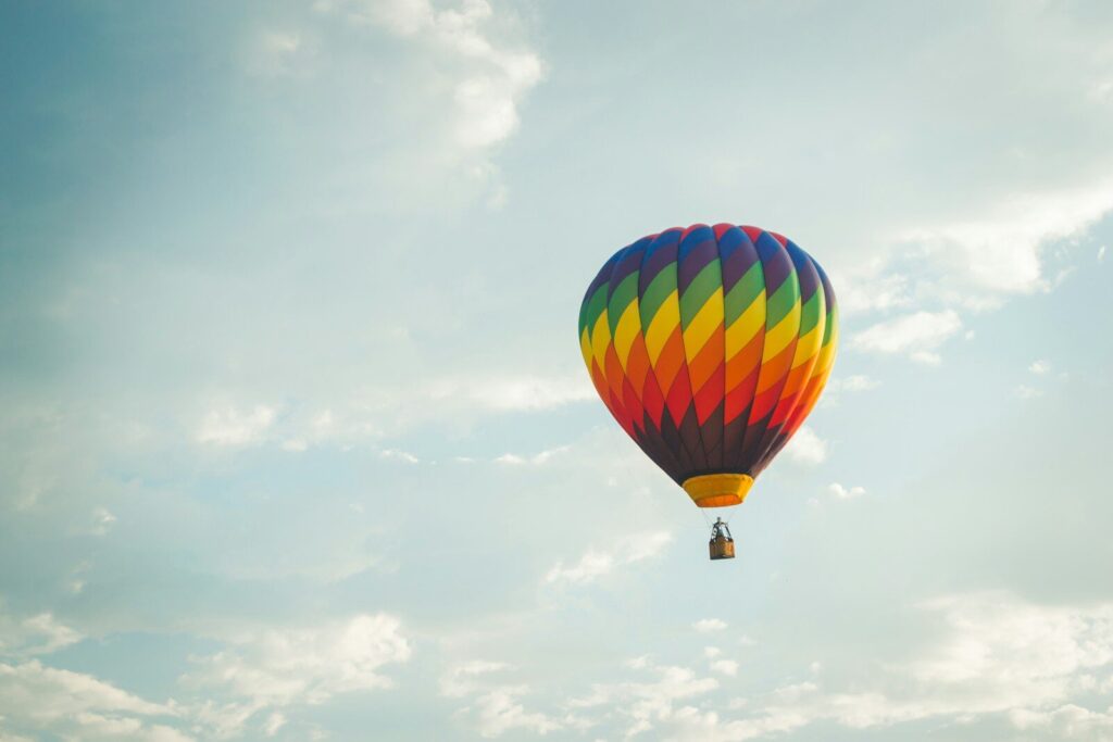 a colorful hot air balloon flying in the sky